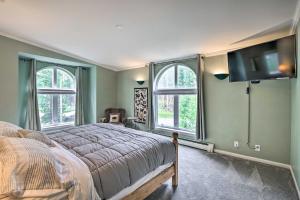 a bedroom with green walls and a bed and windows at Spacious Breck Gem with Hot Tub Walk to Ski Shuttle in Breckenridge