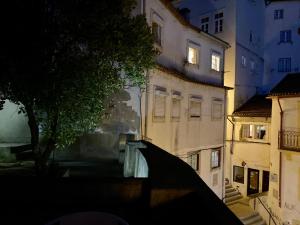 a view of a building in a city at night at SOBRE RIBAS 2|12 in Coimbra