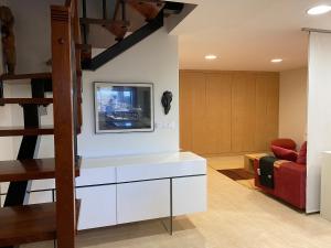 a living room with a tv on a wall at Mar y Sol in Sanxenxo
