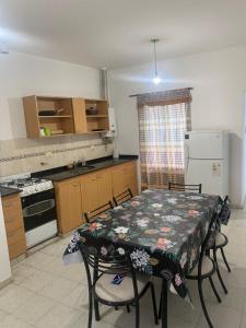 a kitchen with a table and chairs and a kitchen with a refrigerator at Hermoso departamento, excelente ubicación in San Fernando del Valle de Catamarca