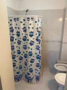 a bathroom with a toilet and a shower curtain at Hermoso departamento, excelente ubicación in San Fernando del Valle de Catamarca