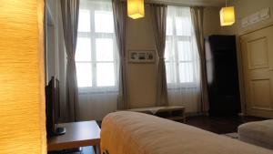 Posteľ alebo postele v izbe v ubytovaní Horvath Villa Apartman