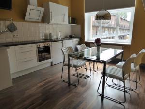 a kitchen with a dining room table and chairs at Berlinapartments-Downtown in Berlin