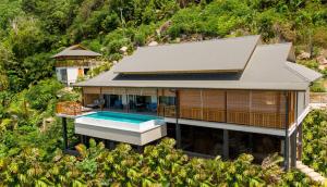 an aerial view of a house with a swimming pool at Paradise Chalets Yoga & Wellness in Takamaka