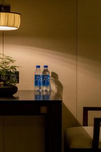 two bottles of water sitting on top of a table at Shenzhen Castle Hotel in Longgang
