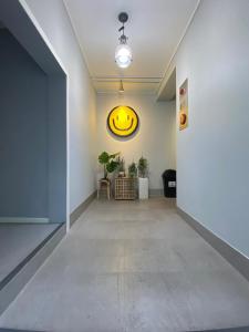 an empty hallway with a smiley face on the wall at Fully Mini Hotel in Seoul
