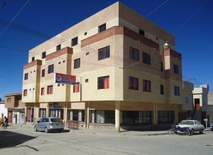 a building with cars parked in front of it at Hotel Frontera in La Quiaca
