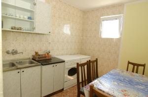 a kitchen with a sink and a dishwasher at Rooms & Apartments Anka in Bar