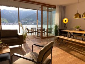 a living room filled with furniture and a large window at Residence Bellevue by Alpin Rentals in Zell am See