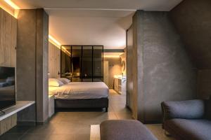 a bedroom with a bed and a living room at Apart! & Moment! in De Haan