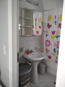 a bathroom with a sink and a mirror at Myconian Cottage in Ano Mera +12 photos