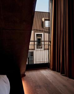 a room with a wooden floor and a window at Karl August - a Neighborhood Hotel in Nuremberg