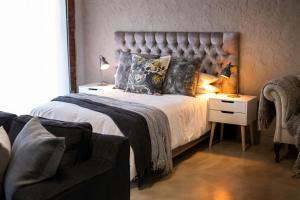 a bedroom with a large bed and a couch at the STUDIO apartment in Durbanville in Durbanville