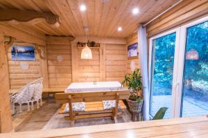a sauna with a table and a bench in a room at U Leona in Gorlice