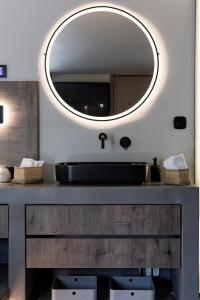 a bathroom with a black sink and a mirror at Kavouri Seaside Luxury Bungalow in Athens