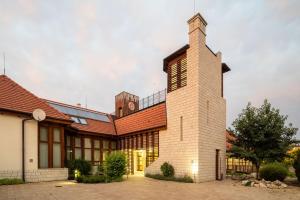 a large building with a tower on top of it at Furmint Ház in Mád