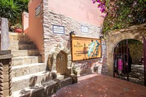 an entrance to a building with a sign on it at Attiki Hotel in Rhodes Town