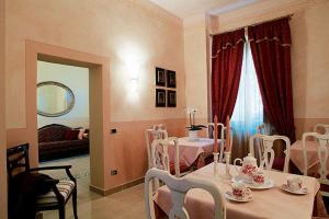 a dining room with a table and chairs and a living room at Villa Della Certosa in Gambassi Terme