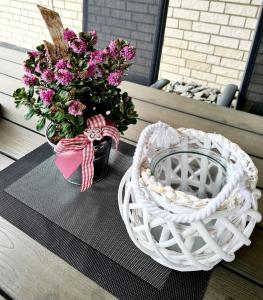 two baskets and a bouquet of flowers on a table at Zum Harzer in Altenau