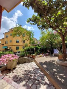 a building with a tree and flowers in a courtyard at Albamare in Monterosso al Mare