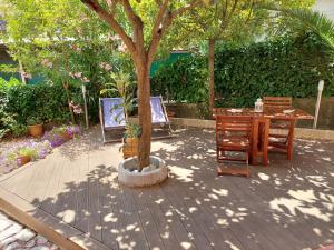 a table and chairs and a tree in a garden at Albamare in Monterosso al Mare