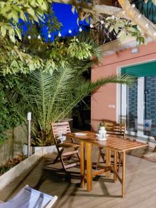 a wooden table and chairs on a patio at Albamare in Monterosso al Mare