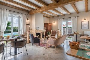 a living room with tables and chairs and a fireplace at Une Escale à Pornic chambres d'hôtes 4 épis in Pornic