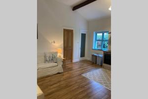 a living room with a couch and a table at DUNGARVAN,beautiful cottage near Comeragh Mountains in Dalligan Bridge