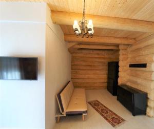 a living room with a couch and a tv at Casa Cartianu in Târgu Jiu