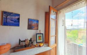 a room with a window and a table with a picture at La Casa Di Dina in Castelmuzio +32 photos