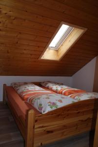 two beds in a room with a skylight at Ferienwohnung Weber in Habach