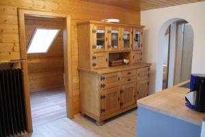 a kitchen with a wooden cabinet in a room at Ferienwohnung Weber in Habach
