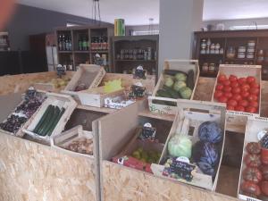 a store with many boxes of fruits and vegetables at Chalet dans village in Saint-Maurice-en-Trièves
