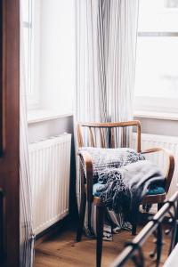 uma cadeira com um cobertor sentado em frente a uma janela em Villa Rosa em Bad Gastein