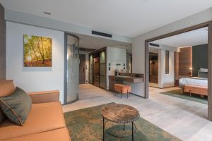 a living room with a couch and a bed at Rivage Hôtel & Spa Annecy in Annecy
