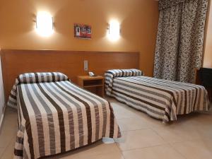 Llit o llits en una habitació de Hotel Avenida El Morell