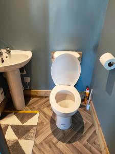 a bathroom with a toilet and a sink at Alderbank, Harrapool, IV499AE in Broadford