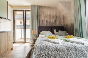 Posteľ alebo postele v izbe v ubytovaní Apartamenty Jedlina