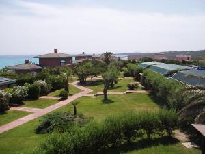 a view of a park with palm trees and houses at Rocca Ruja Vip in Stintino