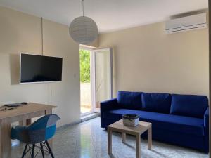 a living room with a blue couch and a table at Villa Zoe Privlaka-Zadar in Privlaka