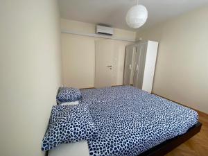 a bedroom with a bed with a blue and white comforter at Villa Zoe Privlaka-Zadar in Privlaka +20 photos