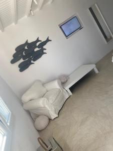 a living room with a white couch and a picture on the wall at Elia Sea View Luxury Villa in Elia Beach