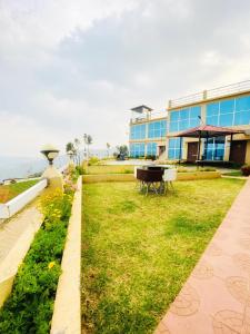 a garden in front of a building at Tulips Valley View Resorts in Ooty