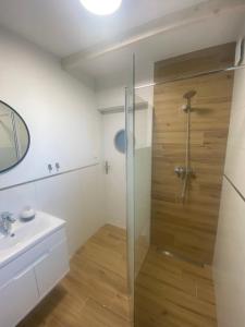 a bathroom with a shower and a sink at Domek Morze in Ustka