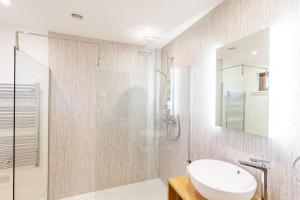a bathroom with a glass shower and a sink at Thistle Lodge 22 with Hot Tub in Belladrum +22 photos