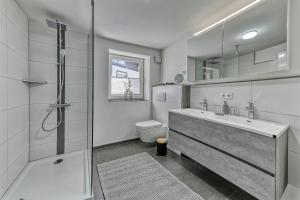 a bathroom with a shower and a sink and a toilet at Ferienhaus Leutner in Bodenmais