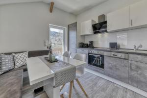 a kitchen with a table and a counter top at Ferienhaus Leutner in Bodenmais