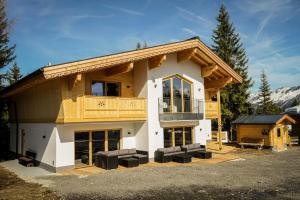 a large log house with a balcony on top at Chalet Zillertal Arena in Krimml