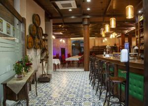 a restaurant with a bar and stools in a room at Hotel Julián in Alhama de Murcia