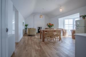 a kitchen and dining room with a table and chairs at Brook Cottage - 7 Bedroom Cottage - Dale in Dale